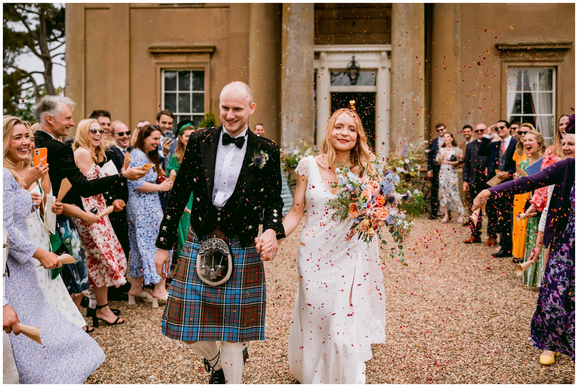 bride and groom walking through confetti at sibton park estate Wedding.